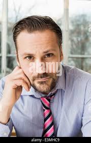 Portrait of confident businessman in front of skyscraper Stock Photo