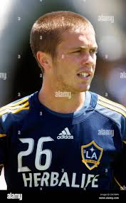 Galaxy midfielder Michael Stephens (#26) dribbles the ball up-field with  Crew midfielder Eddie Graven (#12) in pursuit during first-half game  action. The LA Galaxy defeated the Columbus 2-0 at Crew Stadium in