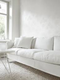 Beautiful All White Minimalist Living Room Interior With Tone On Tone Wallpaper Minimalist Sofa All White Room White Sofas