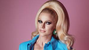 Courtney act is the stage name of shane jenek, a drag queen, performer, music artist, one of the wigs by vanity owners and the bi life tv show hostess, known for being a contestant on season 1 of australian idol and season 6 of rupaul's drag race. The Fluid Evolution Of Mardi Gras Co Host Courtney Act