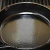 Before seasoning your cast iron pan, wash it with soap and hot water (one of the few times my pans ever see soap). 1