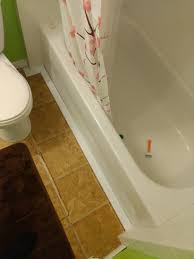 Closed The Gap Between The Old Floor And The New Tub With A Bit Of Plastic Door Sill Trim Should Stop The Cold Basement Dra Floor Molding Flooring Bath Decor