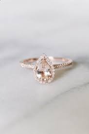 Marriage Rings A Pear Shaped Diamond Engagement Ring With Halo Diamonds Sits Pear Shaped Diamond Engagement Rings Top Engagement Rings Shop Engagement Rings