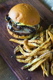 Mushrooms and caramelized onions are tucked into the center of ground beef patties before grilling. Mushroom Burger With Provolone Caramelized Onions And Aioli