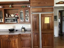 A rustic kitchen with oak cabinetry can be enhanced by the ambient lighting. What Color Should I Paint My Kitchen Cabinets Textbook Painting