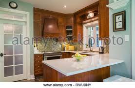 Flat white kitchen cabinets with white quartz countertops. Kitchen With Grey Cupboards And White Countertop Stock Photo Alamy