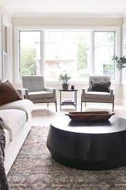 Two chairs flanking a round pedestal table or an octagonal one create a useful space within a larger room. Living Room Seating Adding Cozy Chairs The Diy Playbook Living Room Seating Room Seating Living Room Design Decor