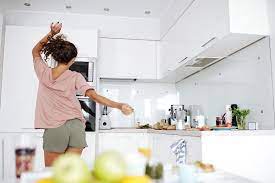 Woman Dancing In The Kitchen By Clique Images
