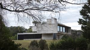 The renovated house is located in famalicão, portugal with tucked away patios inside a triangular urban plot. Luciano Kruk Uses Hanging Volume For A Vacation House Supported By Triangular Column In Argentina