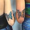 The tattoos are not just drawn but appear to be made out of paper. 3