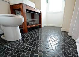 We love how this bathroom committed to white tiles paired with black grout but didn't get stuck using a single style. Small Hexagon Tile Bathroom Floor Decoomo