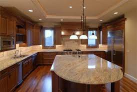 It has a neutral tone granite counter top in the center, is a free standing island with cabinets underneath. Pin By Art On The Decor Boards Brown Kitchen Cabinets Brown Kitchens Dark Kitchen Cabinets