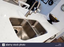 a stainless steel sink in a white