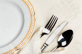Silverware is placed in an even line, one inch from the edge of the table. Table Setting With Plate Fork Knife Spoon And Napkin Stock Photo Picture And Royalty Free Image Image 93525029