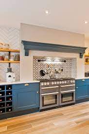 Stone and red brick recessed chimney inset with green aga and mosaic tile surround. 20 Rustic Kitchen Ideas With Contemporary Features You Can Try Kitchen Fireplace Rustic Kitchen Modern Kitchen