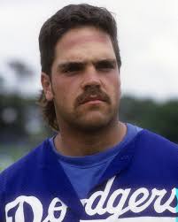 Mike Piazza may have been a 62nd-round draft pick, but he had a 1st-round  mullet! He's got a teal Motorola pager, a car phone in his 5.0 Mustang, and  a 6-pack of