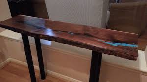 A live edge acacia slab stands on classic matte black hairpin legs. Hand Crafted Live Edge Walnut Console Table W Turquoise Inlay By Texas Vintage Woodshop Custommade Com