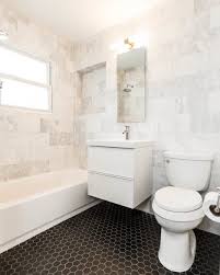 Black And Gold Marble Bathroom Tiles Carrara Marble Bathroom With Black Hex Tile Floor Kovacs Gold Fixture Ikea Vanity By Making Modern H Mid Century Bathroom Classic Bathroom Bathroom Flooring