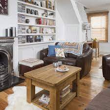Design elements like shelving, hidden storage, accent lighting and a solid color scheme also go a long way in making a small space seem larger. Small Living Room Ideas How To Dress Compact Sitting Rooms And Snugs