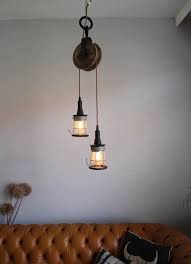 industrial lighting hanging lamp made from a vintage pulley and cage lights loft light ceiling lighting chandelier pendant lights barn industriele lamp hangende lampen industriele verlichting