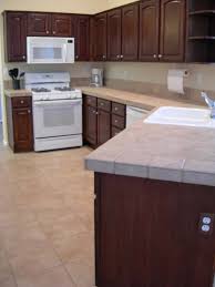 Average Oak Cabinets Get An Upgraded Mahogany Look Painting Oak Cabinets Laminate Flooring In Kitchen Oak Cabinets