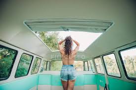 Human anatomy · july 23, 2016. Back View Of Topless Woman With Curly Hair Standing Under Hatch Inside Retro Van In Nature Shorts Three Quarter Stock Photo 222719568