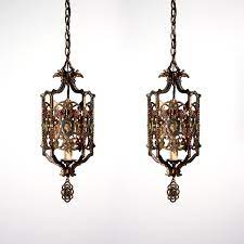 Located in san francisco, ca. Two Matching Antique Spanish Revival Figural Bronze Pendant Lights With Knights