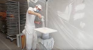 Spraying the first coat of finish on the cabinet door. Painting Cabinets How The Pros Do It Paper Moon Painting