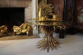 In the background is a white house behind a wall and a tree. The Wheat Table Coco Chanel S Apartment Vintage Furniture Wheat Sheaf Modern Interior Design