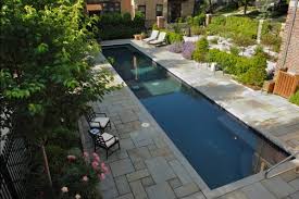 A long, narrow lap pool with an adjoining spa feature from lang pools blends in perfectly with the surrounding rock garden, rows of boxwoods and decking in a design by lang pools that makes the most of a compact yard. Simple Swimming Pools New Berlin Wi Photo Gallery Landscaping Network
