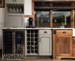Wet bar with wine fridge. Basement Remodeling Contractor Wet Bar Wine Storage Highcraft