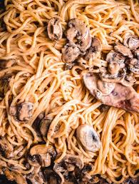 Mixing The Pasta In With The Brandy Mushroom Cream Sauce Brandy Cream Sauce Cream Sauce Pasta Stuffed Mushrooms