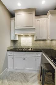 Glass Subway Tile With A Faux Wood Tile Herringbone Floor And Marble Mosaic Framed Accent Above The Glass Subway Tile Glass Backsplash Kitchen Glass Backsplash