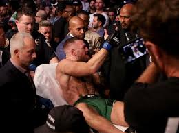 Conor mcgregor was sitting and leaning against the cage, chest heaving. Fyvj Sxeph Uqm