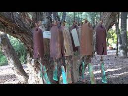 handmade ceramic wind chime features a beautiful carved circle pattern accented by a large copper wind sail bird sculpture wind chimes ceramic birds sculpture