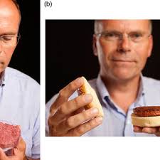 Cultured burger images: Mark Post holds the uncooked cultured burger in... 