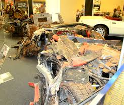 crushed cars, closing sinkhole