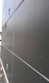 Note:panels may be notched and cut to size to ﬁt between windows, James Hardie Panels In Dark Grey With Exposed Fastening Screws To Give A Rivet Look Exterior Wall Materials House Cladding Exterior Cladding