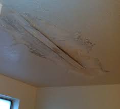 A wet drywall ceiling has to be carefully cut to avoid wires, cables and water lines on the other side. Water Damage In Bathroom Ceiling