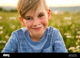 Beautiful little boy in daisy field