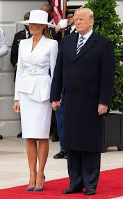 The former model wore covered up in a pair of oversized square sunglasses which had gold detail. Melania Lights Up White House With Huge Hat And That Hand Hold E Online