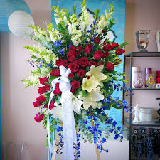 What are the shipping options for red plant pots? The Best Of Red White And Blue Spray By Chita S Floral Designs