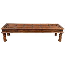 My mom made the coffee table pictured above for $10. Antique Wooden Indian Palace Door Made Into Coffee Table With Iron Braces At 1stdibs