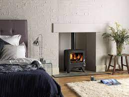 This is an example of a modern bedroom in burlington with white walls, concrete floors and a wood stove. Pin By Sophie Barr On Nice Things For The Home Wood Burning Stove Wood Burner Log Burning Stoves