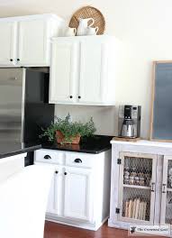 She utilized the space above the cabinets for simple open. Decorating Above Kitchen Cabinets The Crowned Goat