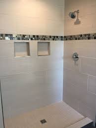 Short of tiling a shower pan, tiling a bathroom floor. Custom Tiled Shower With 12x24 Satiated Tile Run 1 3 Staggered Vertically With A Glass And Metal Mosaic Accent Shower Tile Custom Tile Shower Floor Tile Design