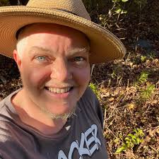 The first FTM contingent at San Francisco Pride (1994). From left to right:  Max Wolf Valerio, Matt Rice, David Harrison, Loren Cameron, and an unknown  marcher. Susan Stryker is in the back