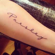 A bold tattoo with foot prints and the name etched above the feet. Cursive Xander Name Tattoo Novocom Top
