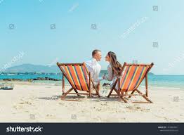 Romantic Holiday Travel Portrait Of Happy Young Couple Hugging Near With Deck Chairs In Luxury Beach Hotel Nea Romantic Holiday Holiday Travel Romantic Photos