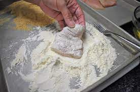 Flip it over, and place it into the flour again to coat the back. Dredging Breading Cook2eatwell